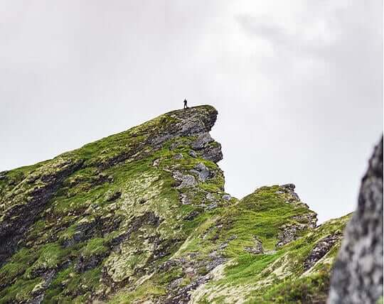 green cliff with grey sky