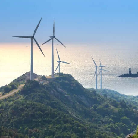 wind turbines on green cliffs and sea